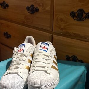 Adidas White Sneakers with Gold Stripes